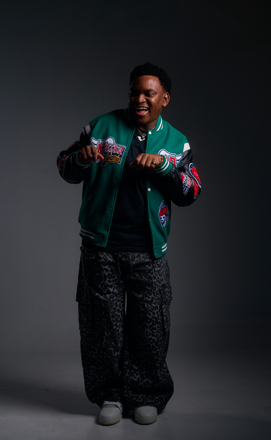 Stylist adjusting an outfit on set during a photoshoot