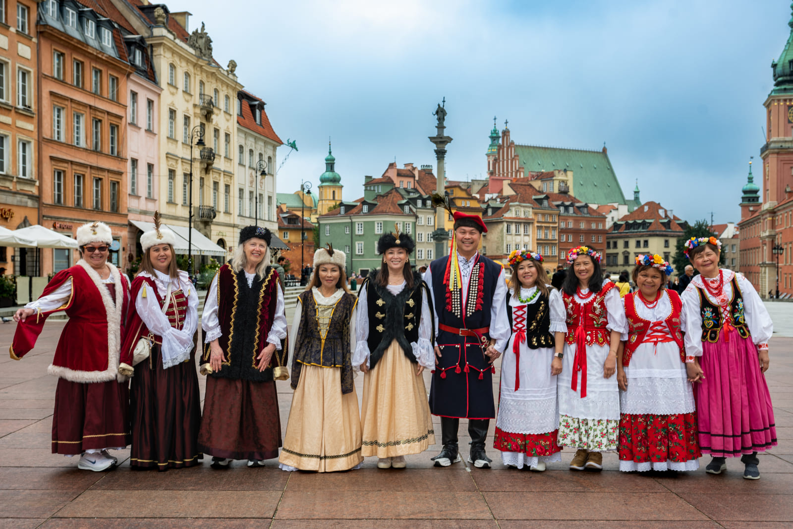 Tourists in traditional Polish folk costumes in Warsaw Old Town